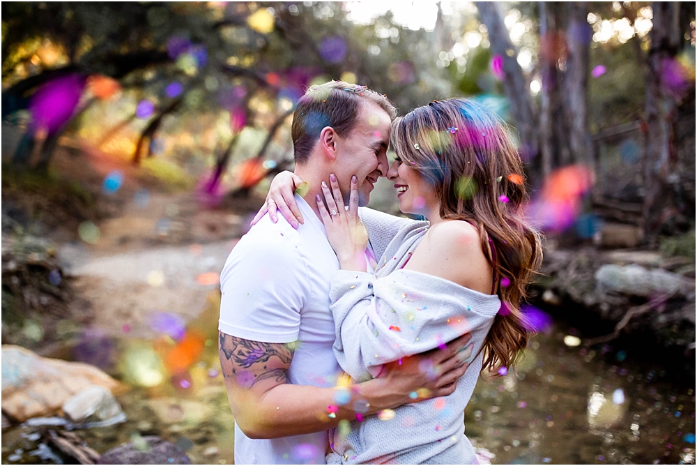 colorful confetti engaged couple cuddle